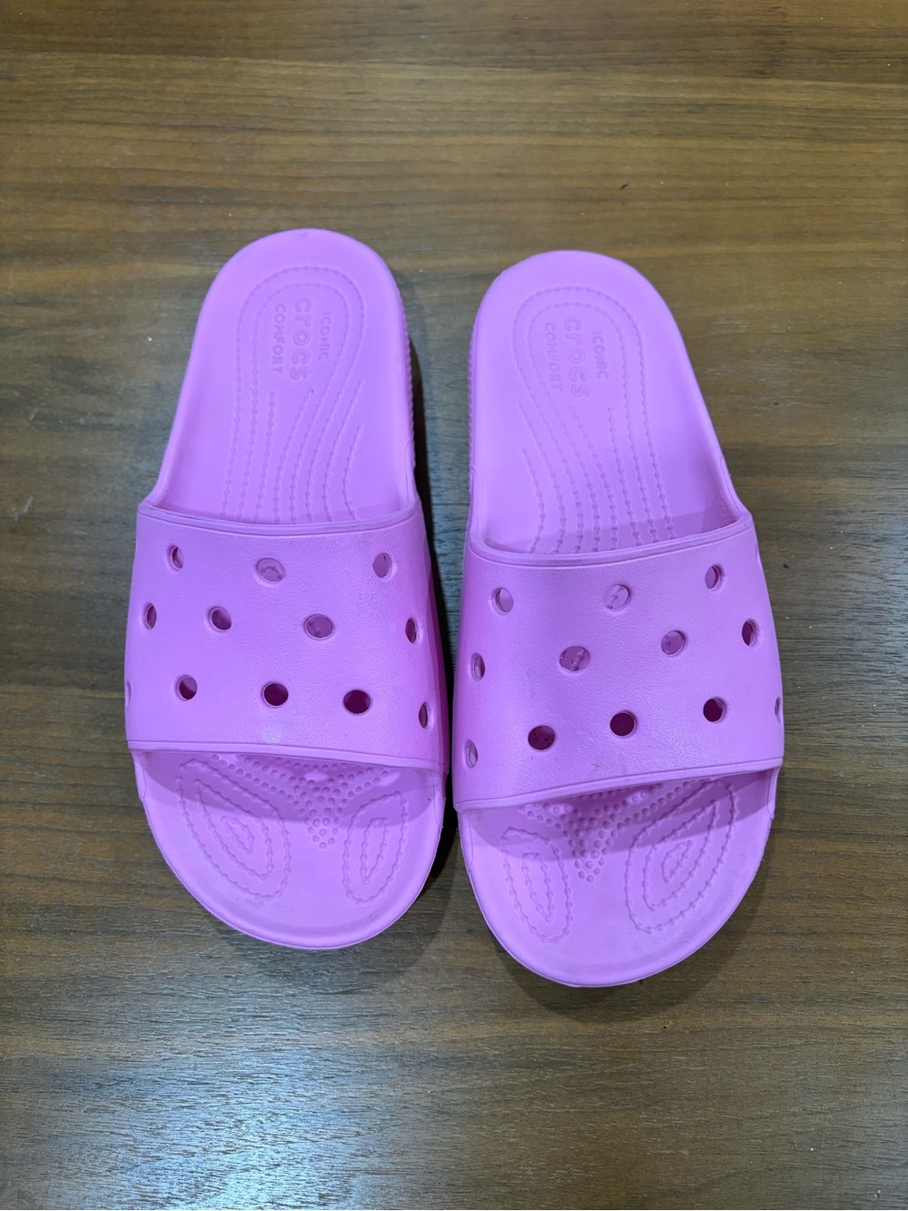 Pink Crocs slides